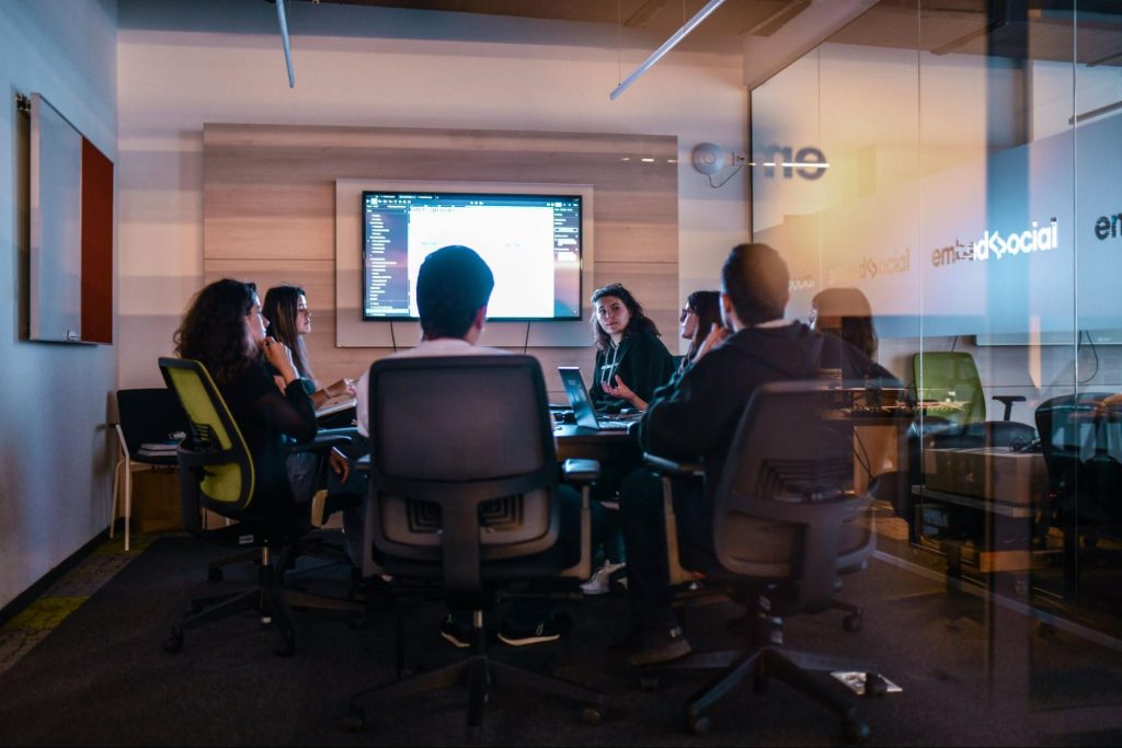 A group of people on a meeting inside a room.